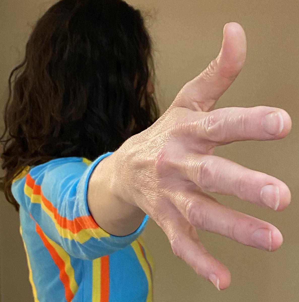Upclose image of dancer's hand outstretched